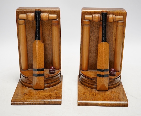 A pair of oak cricket 'bat, ball and stumps' book ends, handmade by Thornton Smith Company, c.1930, 18cm high. Condition - good